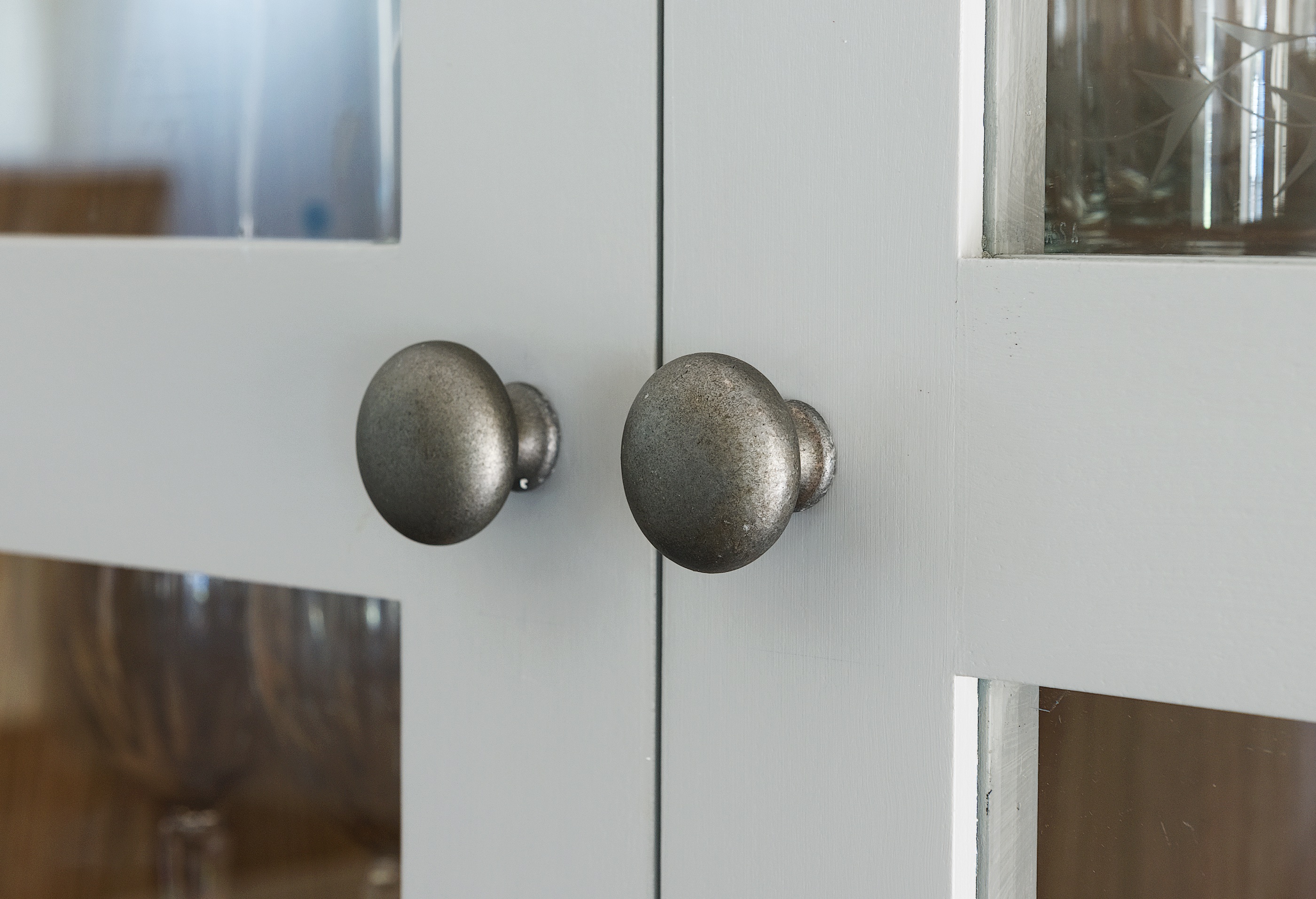 Cast iron cabinet knobs on handpainted grey bespoke dresser.