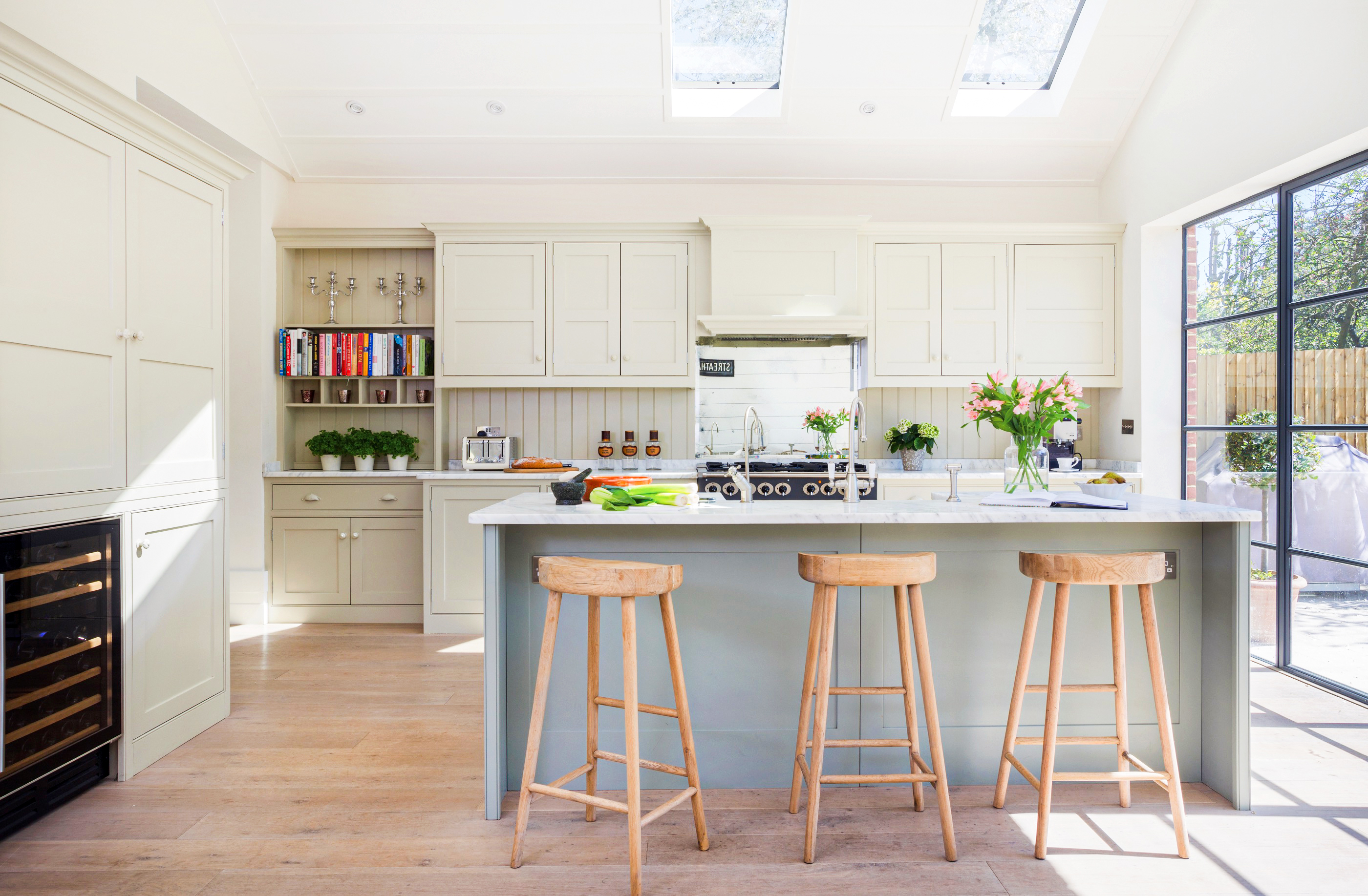 Bespoke kitchen with island painted in Farrow & Ball Pigeon with carrara worktops and Falcon range cooker.