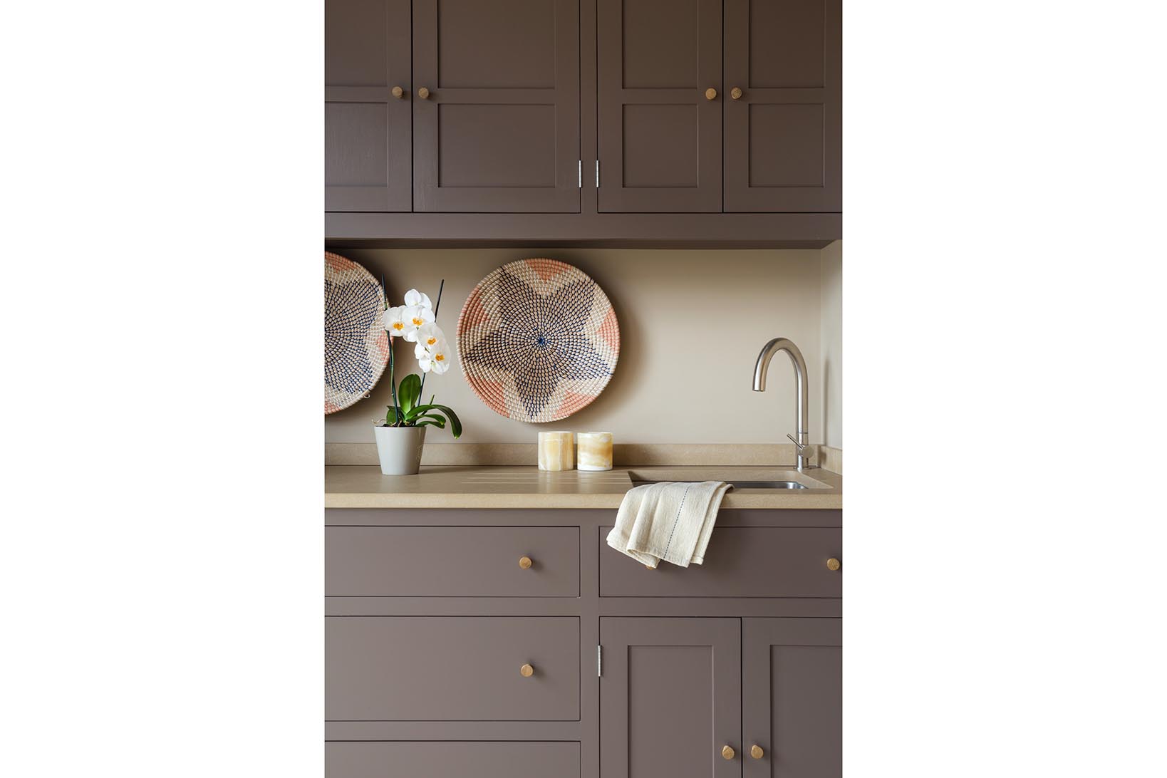 Hand painted cabinets in Farrow & Ball Clay 244 with limestone worktops and Franke stainless steel sink and Adobe tap.