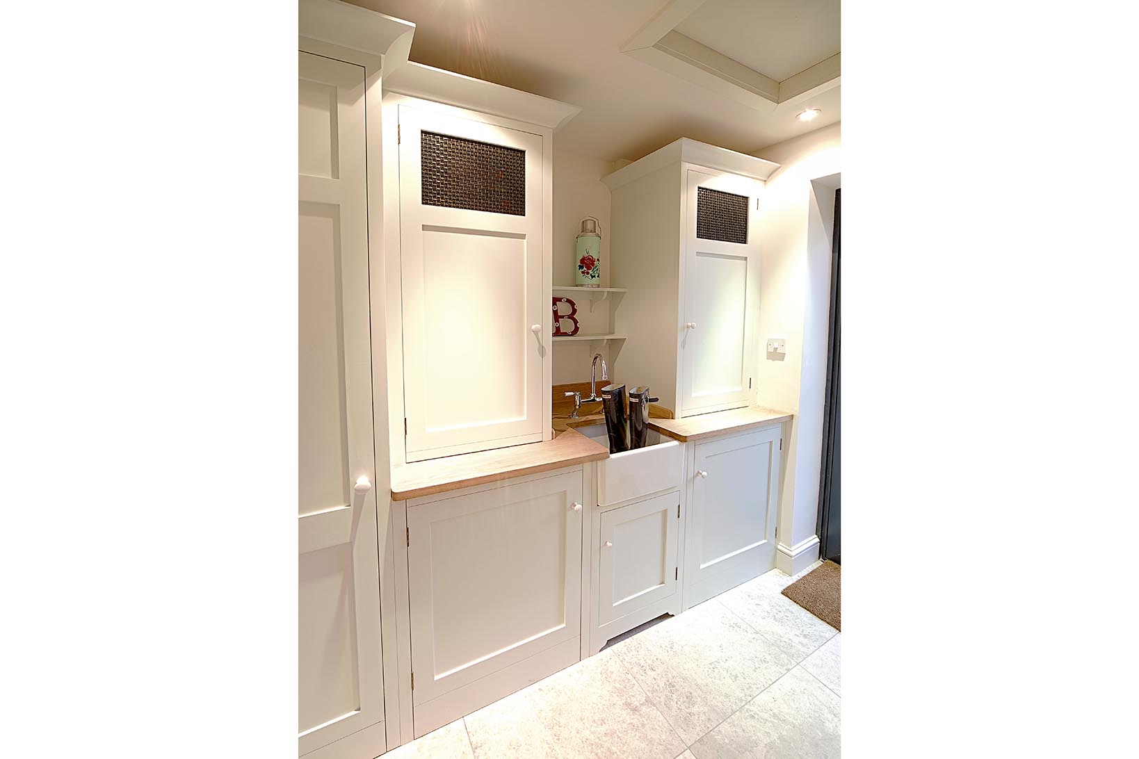Bespoke utility cabinets and oak worktops and a Regis baby Belfast sink and chrome Rangemaster traditional bridge mixer tap.