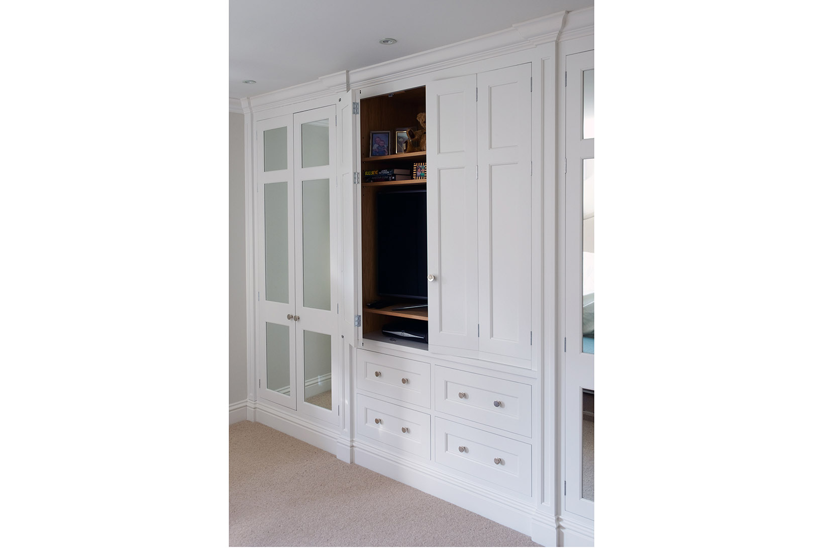 Bespoke shaker built in wardrobes painted in Zoffany Quarter Paris Grey with polished chrome handles and mirrored panels.